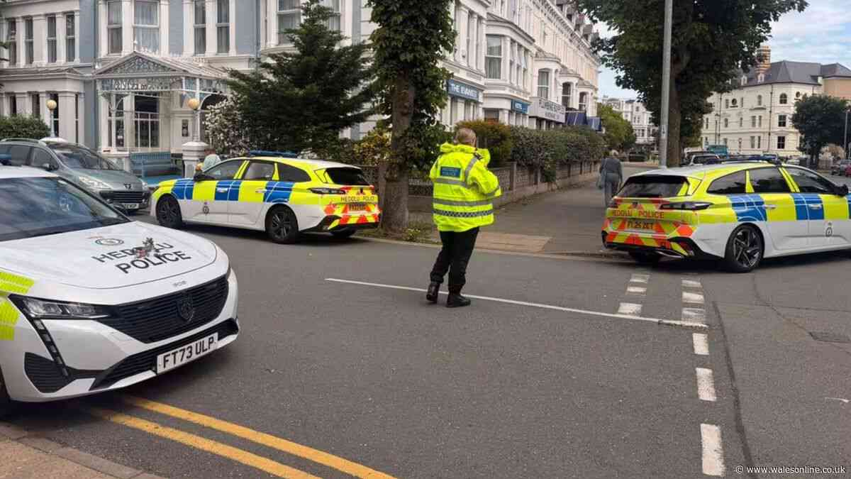 Police rush to hotel with man on roof - live updates