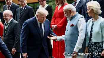 Trump, 80, grips hand of India's Prime Minister Modi during unstabilizing moment on teetering risers
