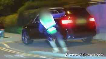 Moment Mercedes almost mows down pedestrian during 100mph police chase before crashing into a tree: Man is arrested on suspicion of burglary and dangerous driving