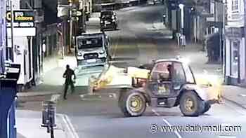 Moment balaclava-clad thieves use a stolen telehandler to rip a cash machine from a Nationwide before lowering it into a getaway truck