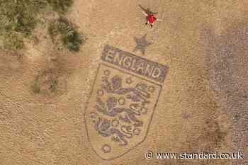 Artist crafts England badge on beach as World Cup campaign nears kick-off