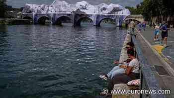 Crowds flock to JR's giant cave installation on Paris' Pont Neuf