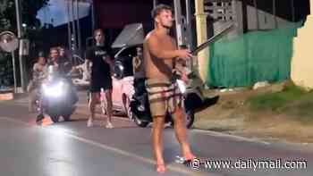 Moment British tourist is attacked and wounded by sword-wielding martial arts instructor 'following road rage rampage' in Thailand