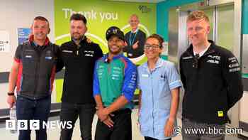 Racer's visit brings boost to patients