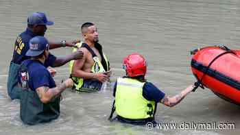 Deadly Tropical Storm Arthur wreaks havoc across the South bringing '1-in-200-year rainfall' with roads underwater and families stranded
