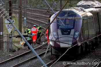 Two trains collide north of London, killing at least 1 person and injuring dozens