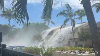 Gargantuan waves crash over ROOF of two-story beachfront condo causing major damage