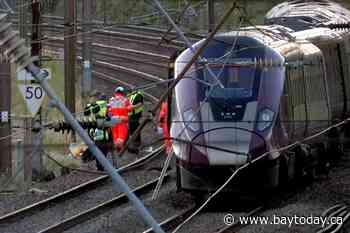 Two trains collide north of London, killing at least 1 person and seriously injuring dozens
