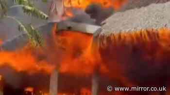 Woman dead and 1,700 evacuated after huge fire rips through luxury beach resort