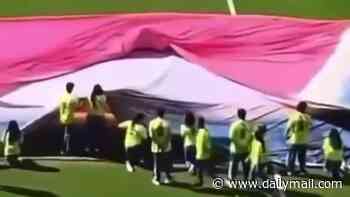 Scary moment volunteer is swallowed up by giant World Cup flag after tripping in pre-game ceremony
