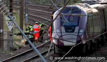 U.K. police probe cause of train collision that killed driver and left 9 in critical condition