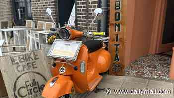 Traffic warden issues parking ticket to decorative Vespa mascot that was on display outside family-run restaurant