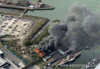 Building on fire beside Kent river as smoke billows into sky