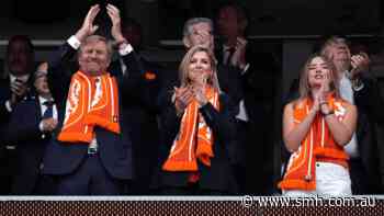 Dutch royals swap orange for blue as they cheer for two teams at the World Cup