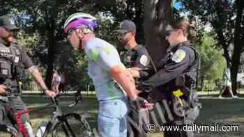 US Olympian who was arrested for allegedly vandalizing Reflecting Pool hits back at Trump's 'lies' and shares new photo... as dramatic video shows confrontation with cops