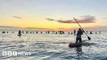 More than 100 paddleboarders mark summer solstice
