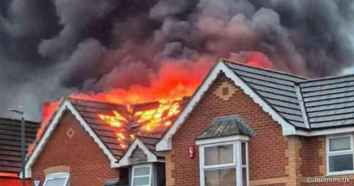 House bursts into flames after being struck by lightning in thunderstorm