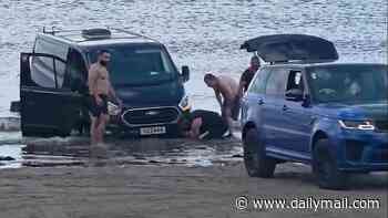 Moment £120,000 Range Rover is swamped by rising tide after owner gets luxury SUV stuck while trying to tow friend's van