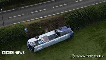 Nineteen injured after bus overturns in crash near roundabout