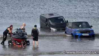 Range Rover submerged by tide on UK beach after owner tries to tow friend's car