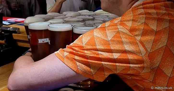 Dutch fan epically carries 26 pints of beer from the bar to his table – in one go