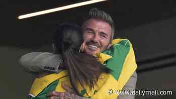 David Beckham shares a sweet hug with Cruz's girlfriend Jackie Apostel on a family night out at the Scotland World Cup game as Brooklyn hits them with yet another swipe amid bitter feud