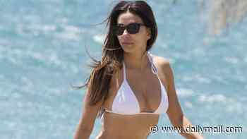 Eva Longoria, 51, drops jaws in white string bikini as she displays gym-honed body during family beach day in Spain... after fleeing US