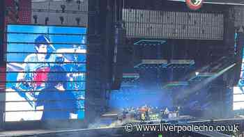 Foo Fighters bring man onstage after sign spotted at Anfield show