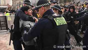 Chaos erupts at Federation Square with a fan dragged out by police as the Socceroos go to half-time 0-0 against Paraguay after dominating possession in nail-biting World Cup clash
