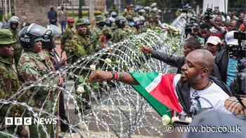 Families lay flowers on barbed wire barricade on anniversary of deadly Kenya protests