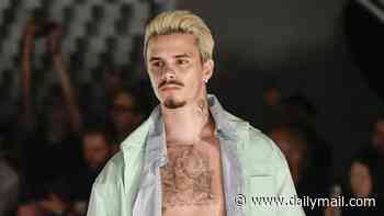 Romeo Beckham shows off his abs as he walks the runway for Willy Chavarria during Men's Paris Fashion Week
