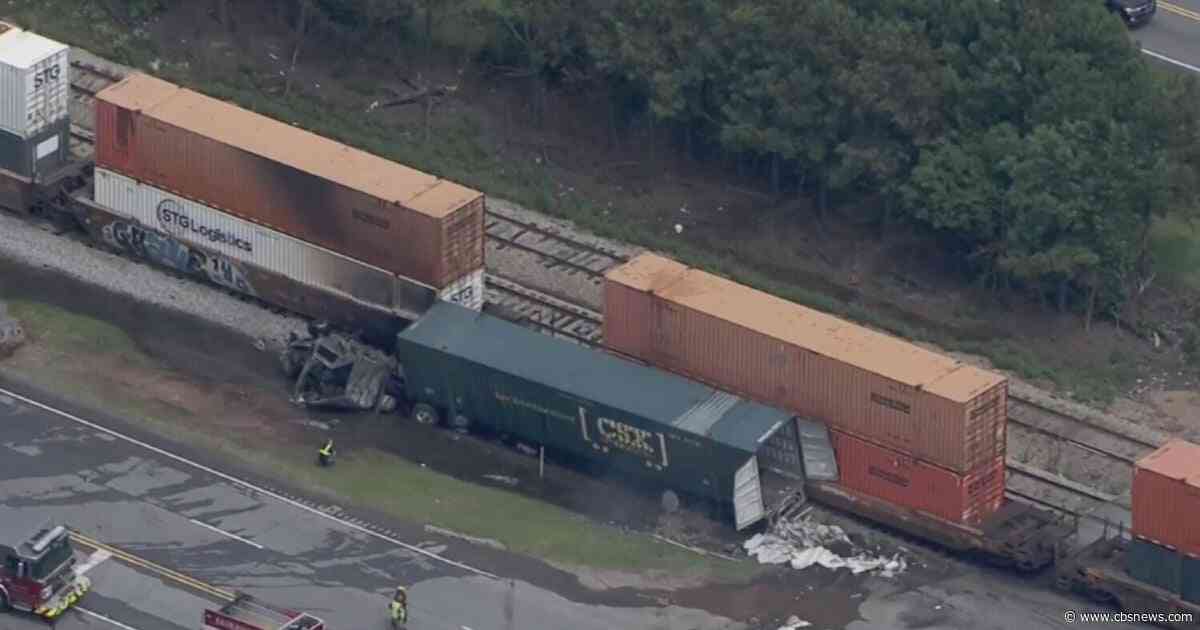 Fiery crash between train and semi-truck shuts down Atlanta road