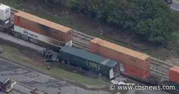 Fiery crash between train and semi-truck shuts down Atlanta road
