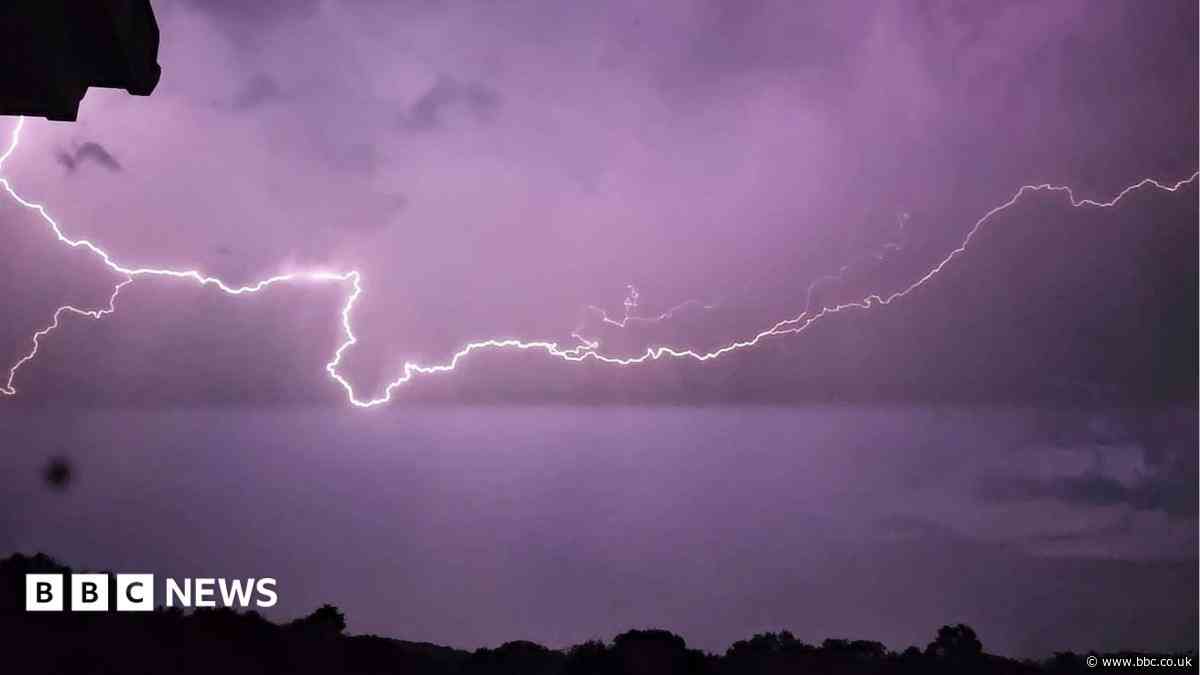 In pictures: Lightning strikes light up sky after hottest day