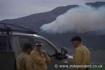 Fast-moving wildfire spreads through western US as restrictions put in place