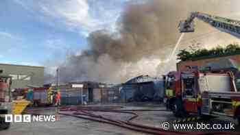 Firefighters battle large warehouse blaze