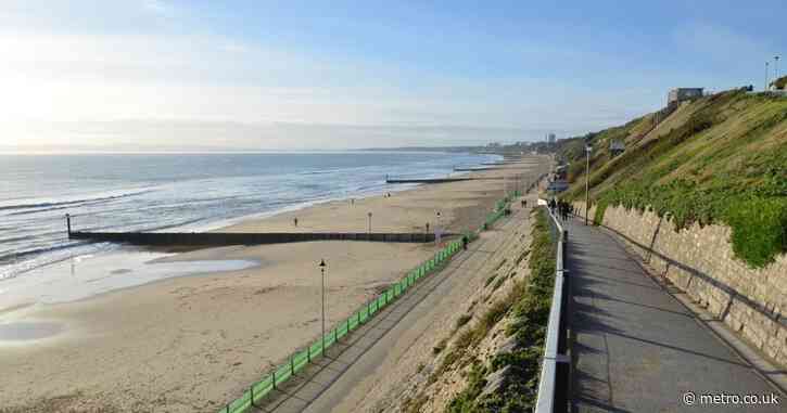 Man dies after falling from 100 ft cliff in front of beachgoers