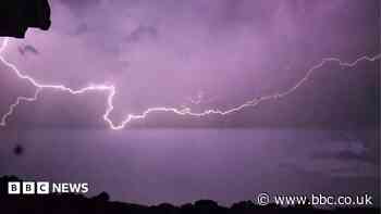 In pictures: Lightning strikes light up sky after hottest day