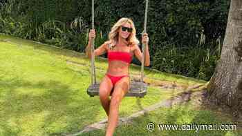 Amanda Holden, 55, strips down to a tiny red bikini as she makes the most of the UK heatwave