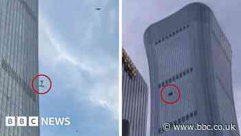 Debris falls after plane hits Beijing's tallest building