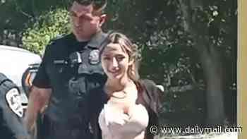Two young sisters smile for the camera as they're arrested for stabbing mom-of-five to death in broad daylight
