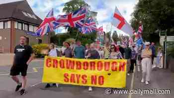 Protesters march in Crowborough to oppose decision to use former military site to house migrants until 2030