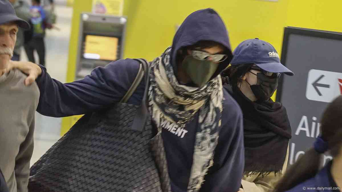 Accessories worth a staggering $30,000 give away Jacob Elordi and Kendall Jenner's identities as A-list couple attempt to go incognito at Brisbane Airport