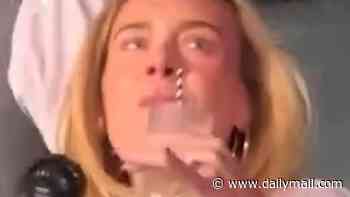 Margot Robbie blends in with concertgoers as she wears a baseball T-shirt and tiny shorts while partying at the Bad Bunny concert in London