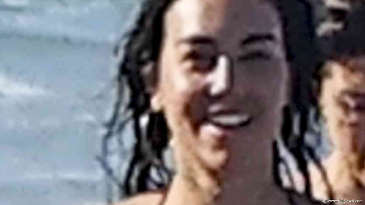 Cristiano Ronaldo's fiancée Georgina Rodriguez shows off her bombshell curves in a black bikini as she hits the beach with friends in Miami during the World Cup