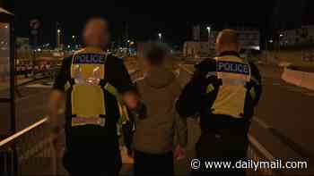 Moment migrant is caught jumping out of a lorry at Port of Dover trying to LEAVE the UK and pleads with police: 'I just want to go back to France!'
