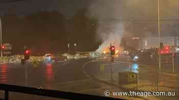 Trail of burning rubbish dumped on busy Bell Street as garbage truck ignites