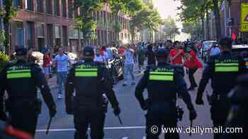 Huge crowds of Morocco fans clash with Dutch police as they celebrate their team dumping the Netherlands out of the World Cup