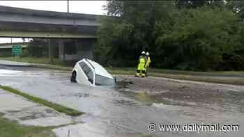 Harrowing moment woman is nearly killed inside 7ft sinkhole until brave officer runs to rescue