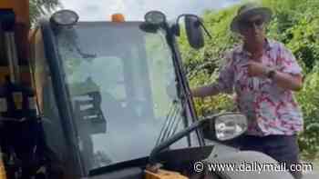Moment wealthy businessman drives his JCB toward Olympic champion who was protesting against new waste incinerator